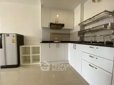 Modern kitchen with sleek white cabinets and stainless steel appliances