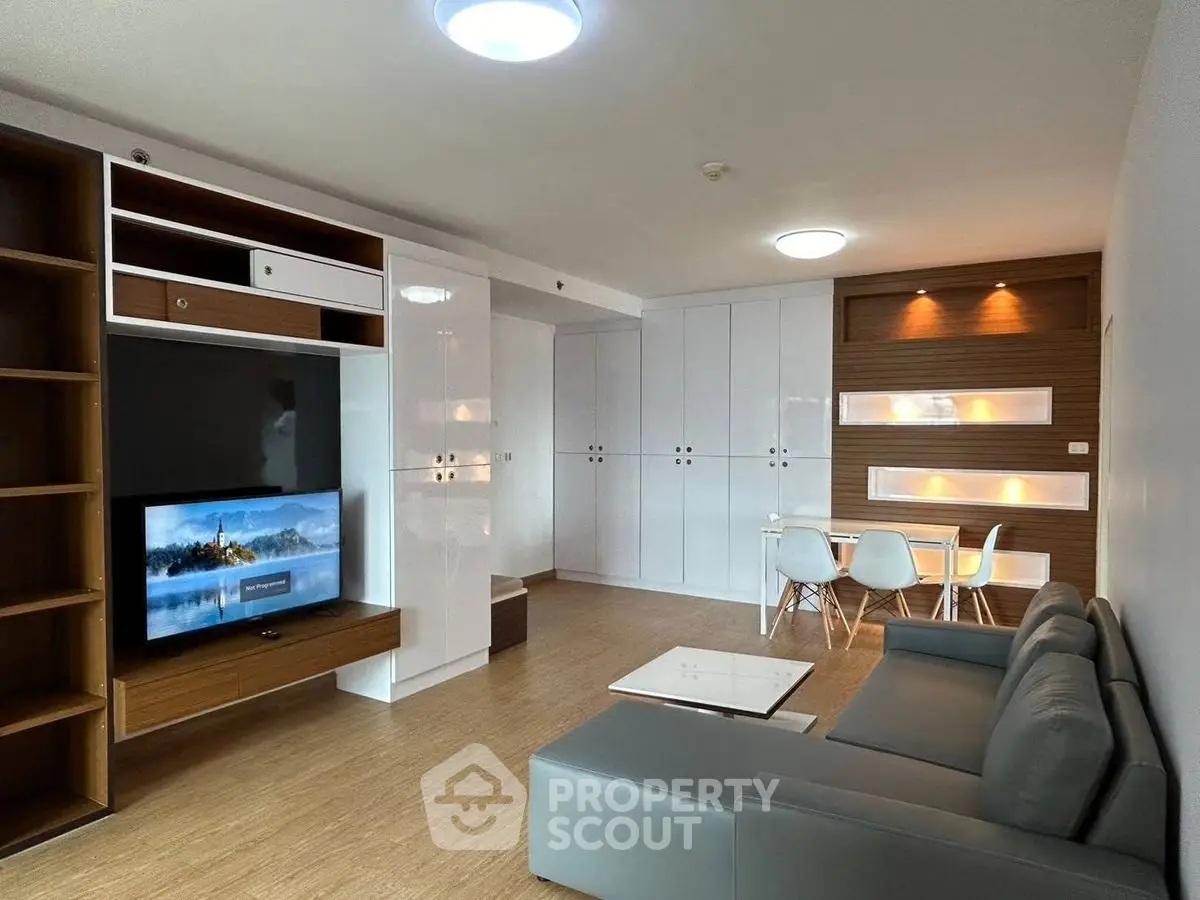 Spacious modern living room with sleek furniture and built-in storage, perfect for stylish urban living.