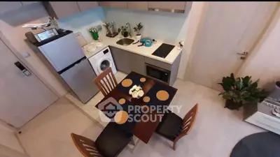 Modern compact kitchen with dining area, featuring appliances and stylish decor.