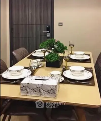 Elegant dining area with modern table setting and stylish decor in a contemporary apartment.