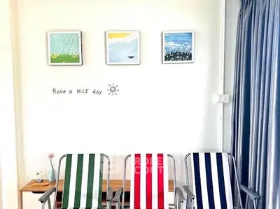 Bright interior with colorful striped chairs and cheerful wall art, perfect for a cozy living space.