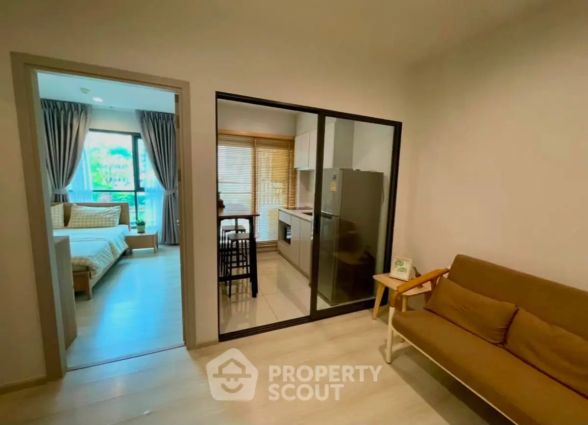 Modern apartment interior with cozy living room, stylish kitchen, and inviting bedroom view.