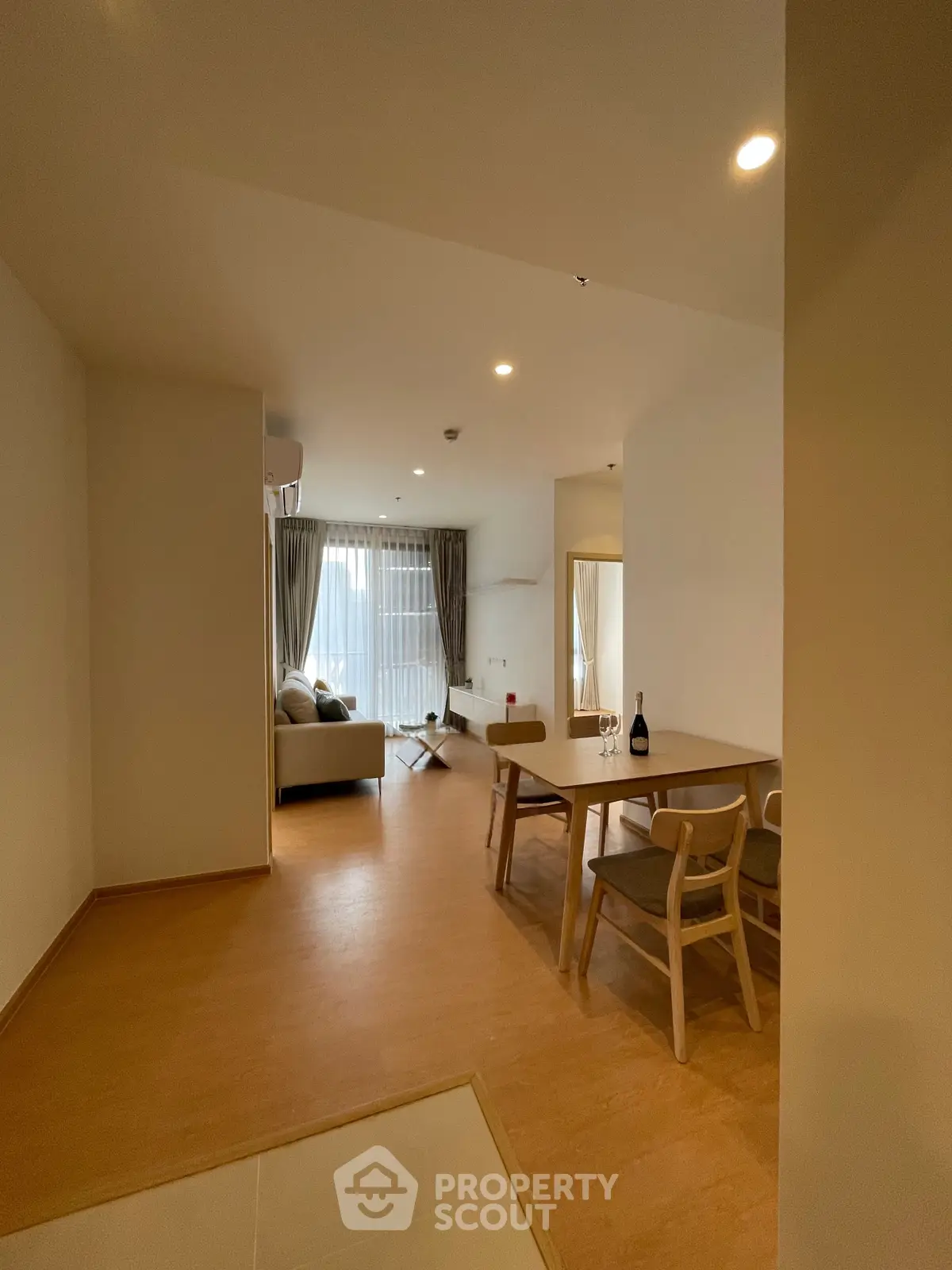 Spacious living room with modern furniture and natural light, perfect for relaxation and entertaining.