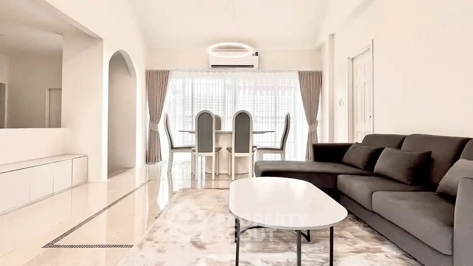 Spacious modern living room with elegant dining area and stylish furniture.