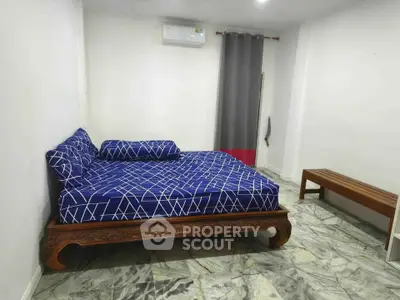 Spacious bedroom with elegant wooden bed and modern decor