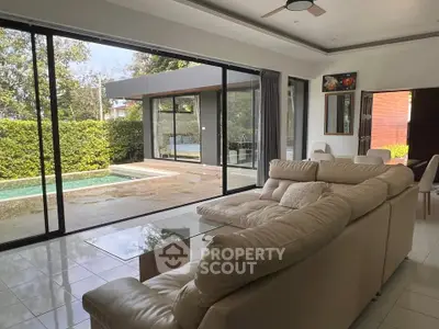 Luxurious living room with pool view and modern sliding glass doors