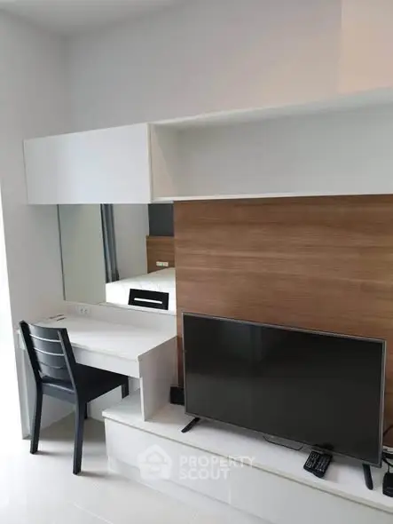 Modern living room with sleek TV setup and stylish desk area