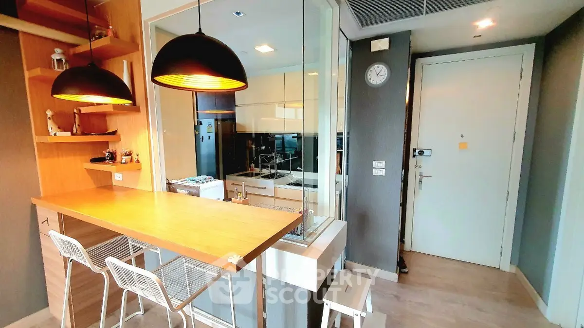 Modern kitchen with open layout and stylish breakfast bar in contemporary apartment.