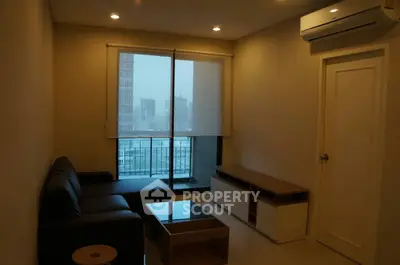 Modern living room with sleek furniture and city view balcony