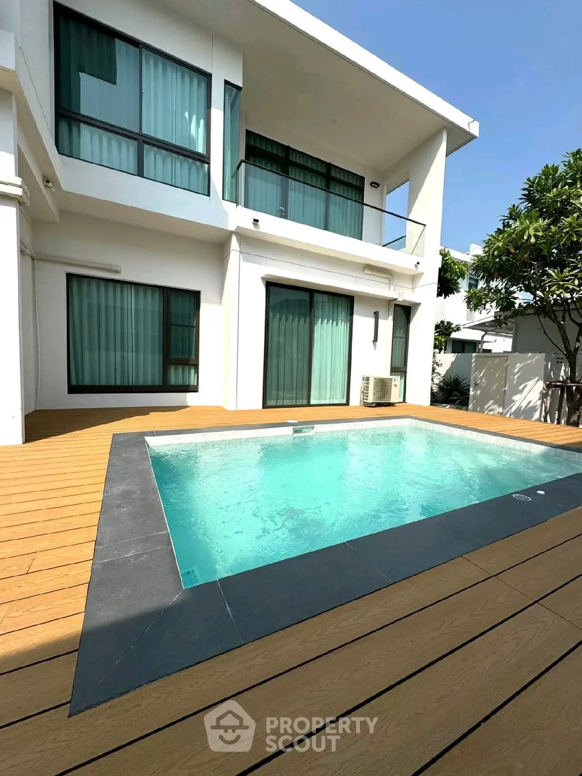 Luxurious modern home with private pool and spacious deck area.