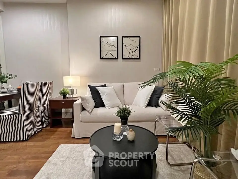 Stylish living room with cozy sofa, elegant decor, and warm lighting, perfect for relaxation and entertaining.