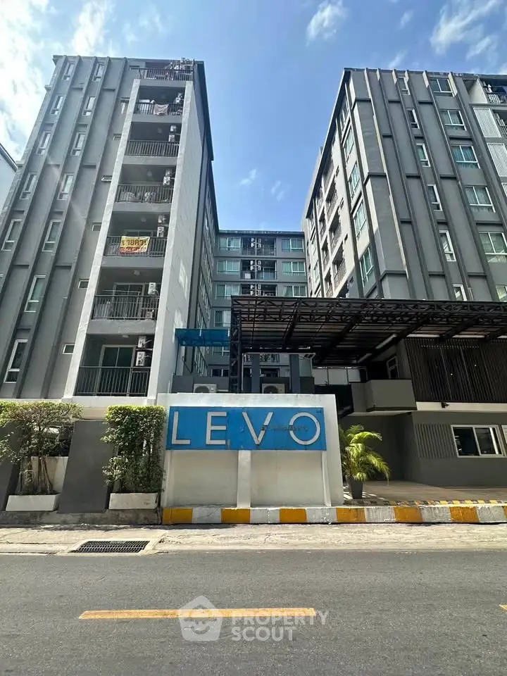 Modern urban apartment building with sleek design and prominent LEVO signage.