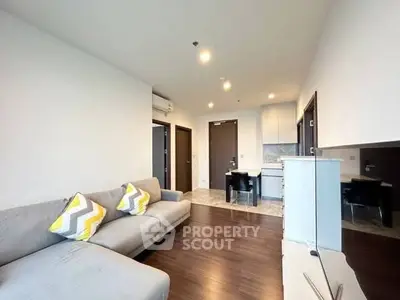 Modern living room with sleek design and cozy seating in a stylish apartment