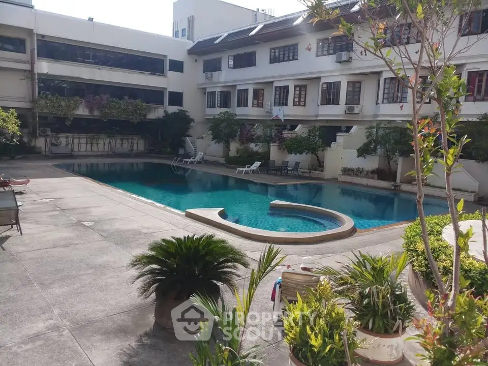 Luxurious residential complex with inviting swimming pool and lush greenery, perfect for relaxation and leisure.