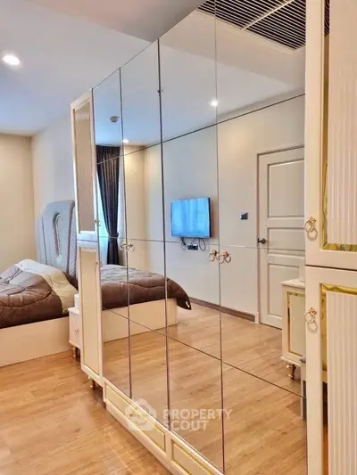 Luxurious bedroom with mirrored wardrobe and modern decor