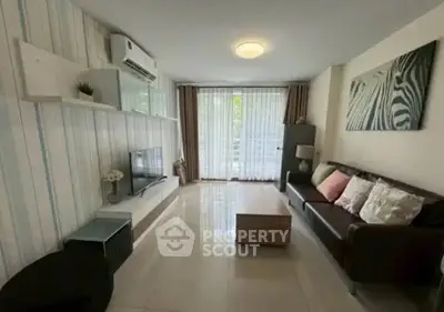 Modern living room with sleek design and natural light, featuring a cozy sofa and stylish decor.