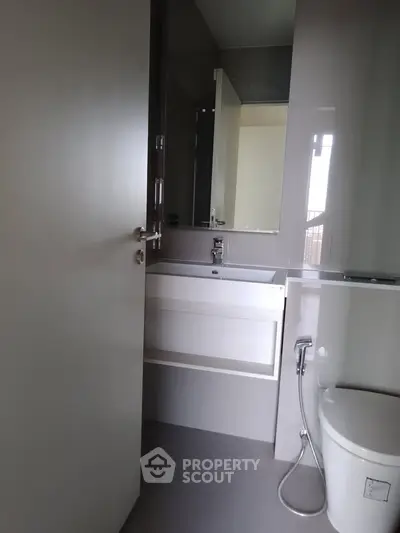 Modern bathroom with sleek fixtures and a bathtub, showcasing contemporary design.