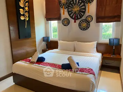 Elegant bedroom with stylish decor and natural light, perfect for relaxation and comfort.