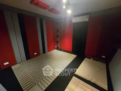 Soundproof room with acoustic panels and air conditioning, ideal for home studio or media room.