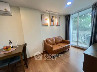 Cozy living room with leather sofa and balcony view in modern apartment