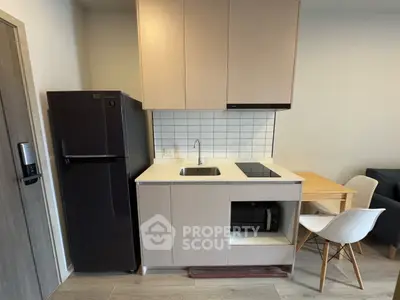 Modern compact kitchen with sleek appliances and minimalist design