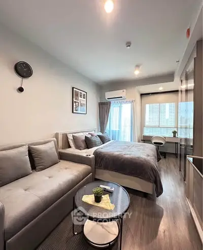 Modern studio apartment with cozy living area and stylish decor