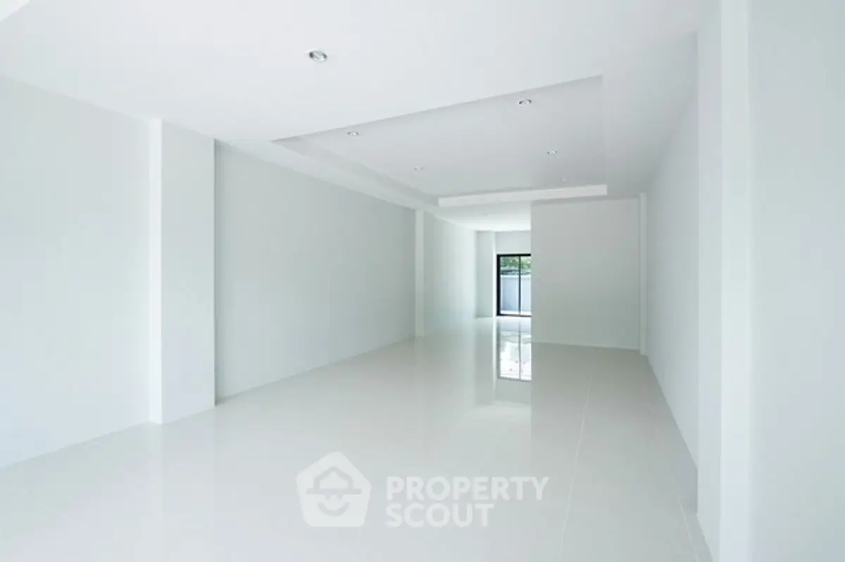 Spacious empty room with modern white interior and large windows