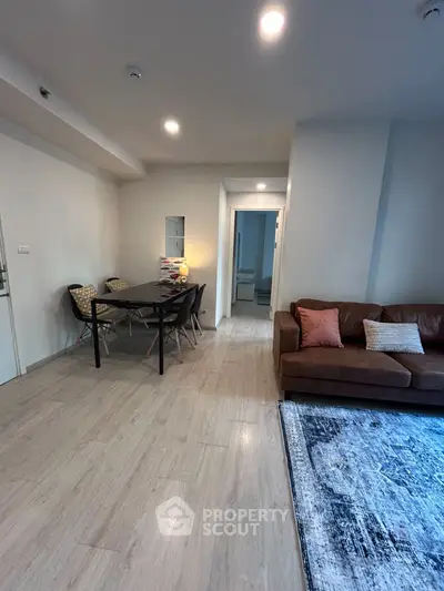 Spacious living room with modern decor and dining area, perfect for entertaining.