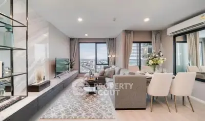 Spacious modern living room with city view, elegant decor, and cozy seating area.