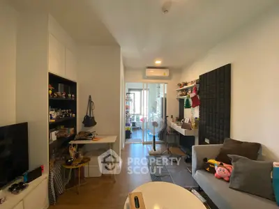 Cozy living room with modern decor and balcony access