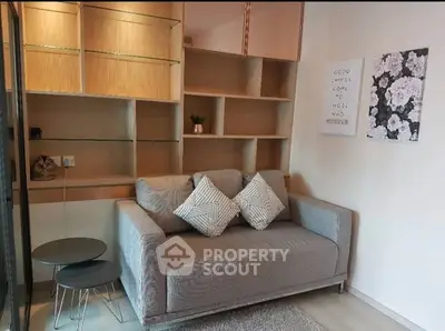 Cozy living room with modern sofa and stylish shelving, perfect for relaxation and comfort.
