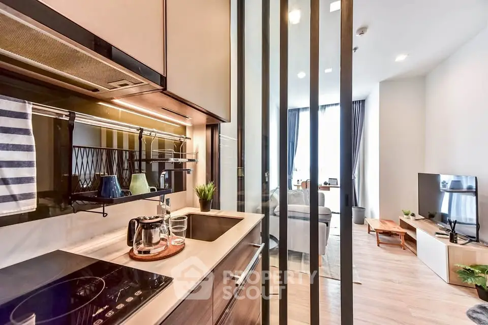 Modern open-layout kitchen with sleek appliances and cozy living room view