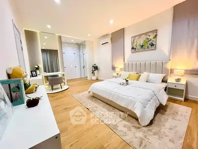 Spacious modern bedroom with elegant decor and cozy ambiance, featuring a stylish study area and ample natural light.