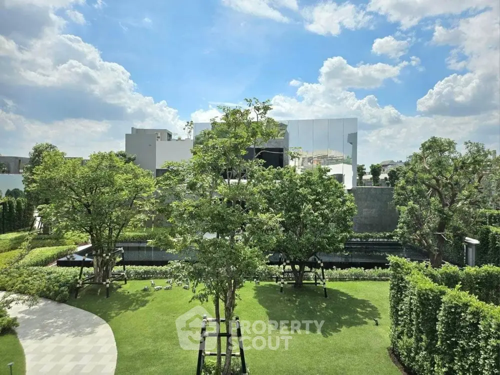Luxurious modern building with lush green garden and clear blue sky view