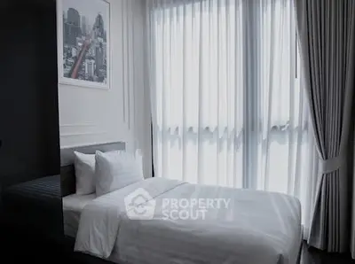 Modern bedroom with large window and elegant curtains in a stylish apartment.