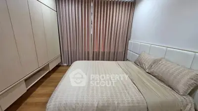 Cozy bedroom with elegant curtains and spacious wardrobe in modern apartment.