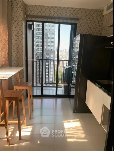 Modern kitchen with balcony view in high-rise apartment
