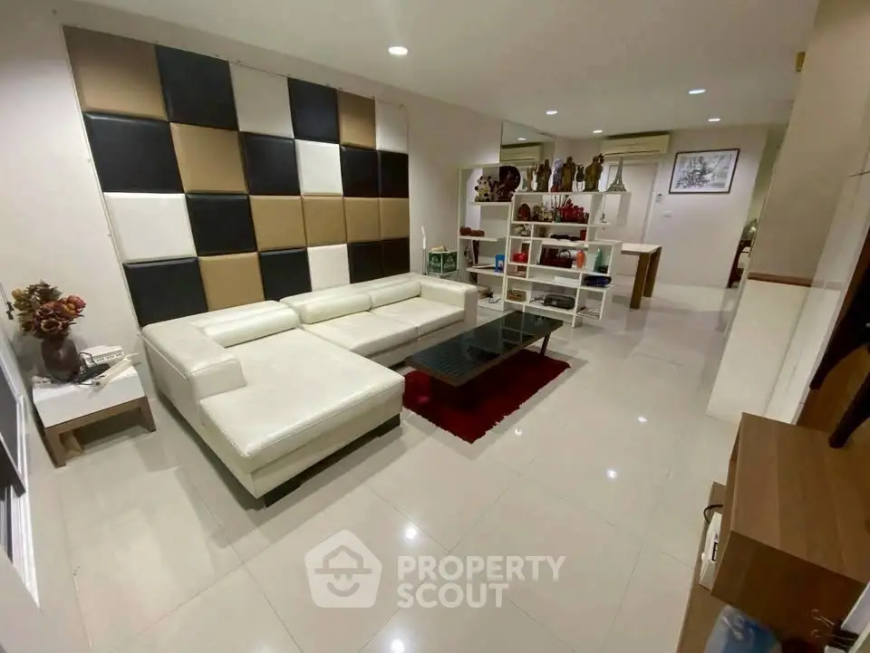 Spacious modern living room with stylish decor and white leather sectional sofa