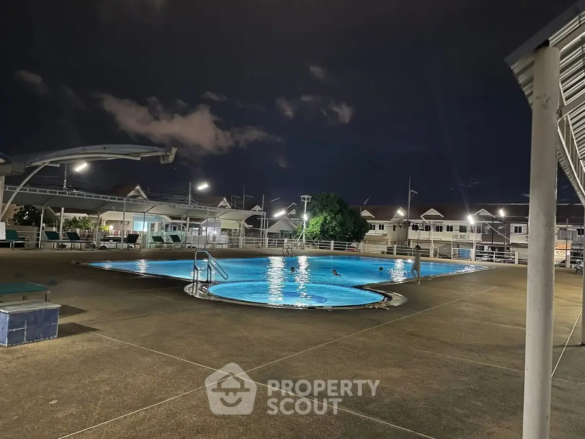 Stunning night view of a residential swimming pool with ambient lighting.