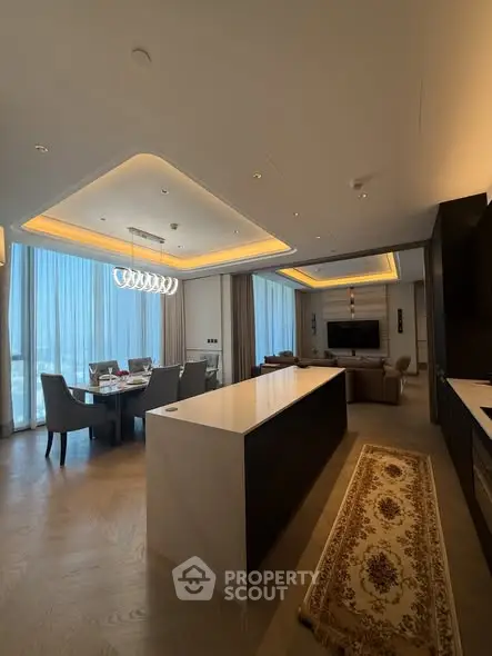 Luxurious open-plan living and dining area with modern lighting and elegant decor.