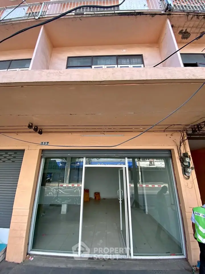 Charming commercial space with glass facade in bustling urban area, ideal for retail or office use.