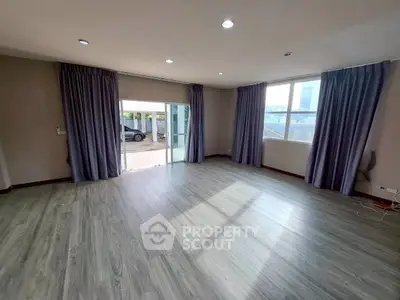 Spacious empty living room with large windows and modern flooring