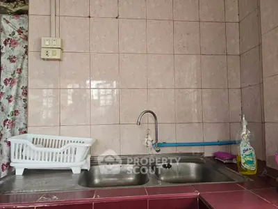Charming kitchen with dual sink and vintage tile backsplash, perfect for cozy culinary adventures.