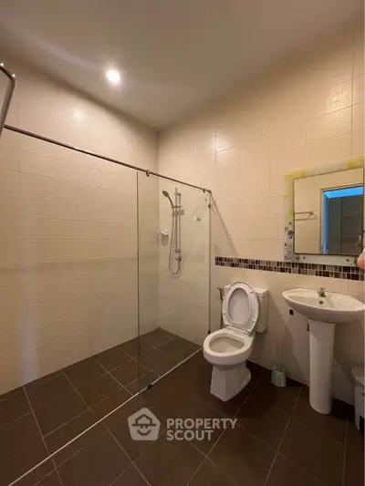 Modern bathroom with glass shower and sleek fixtures in a contemporary home.