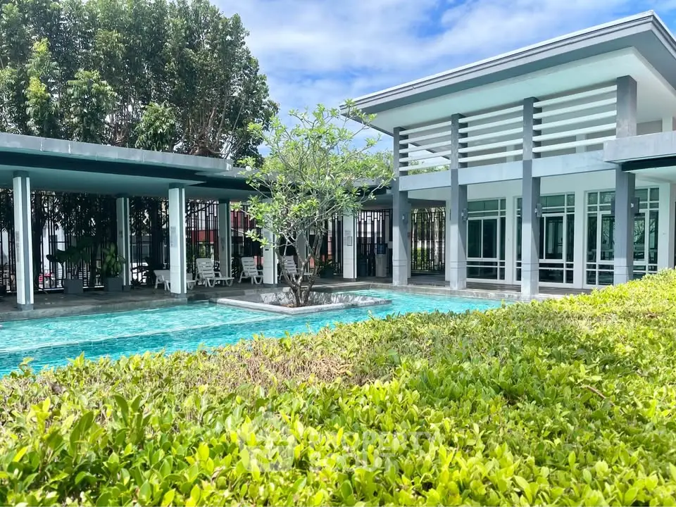 Modern building with pool and lush greenery, perfect for luxury living.