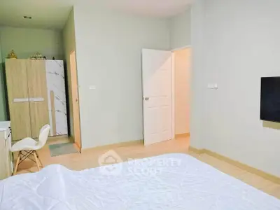 Spacious bedroom with modern decor and ample natural light