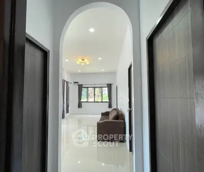 Spacious modern living room with elegant archway and natural light