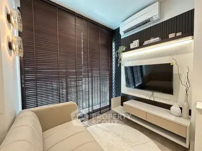 Modern living room with sleek design, featuring a wall-mounted TV, stylish blinds, and contemporary lighting.