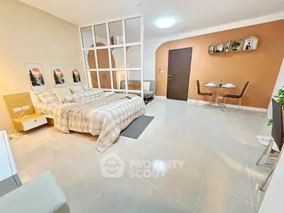 Spacious modern bedroom with stylish decor and dining area, perfect for comfortable living.
