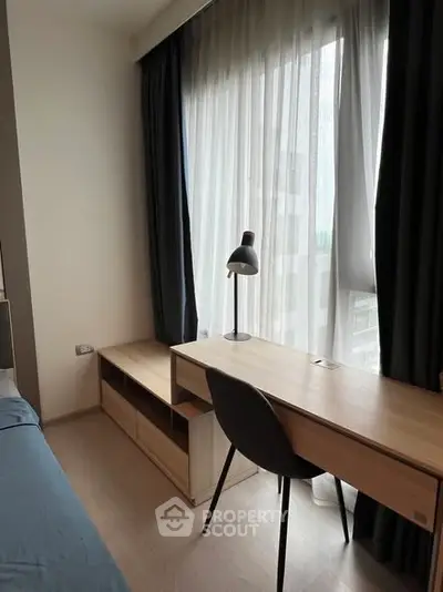 Modern study area with sleek desk and chair by a large window, perfect for productivity.